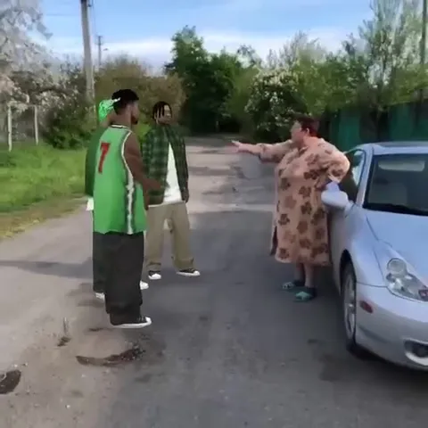 Женщина спорит с парнями у машины