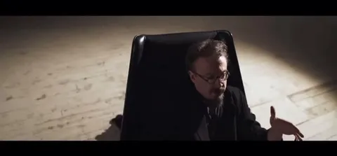 Man Explaining in a Chair