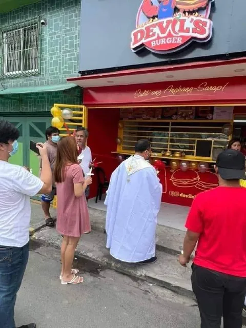 Priest Blessing a Burger Shop