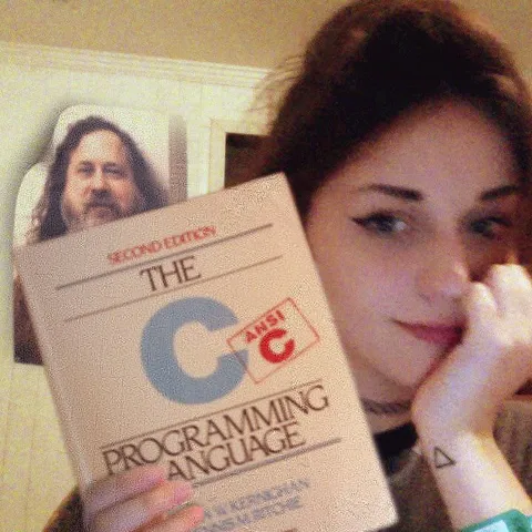 Woman Holding The C Programming Language