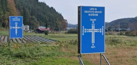 Life Is Death's Grave Sign