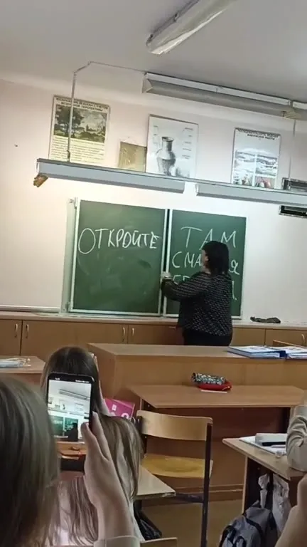 Учительница открывает доску