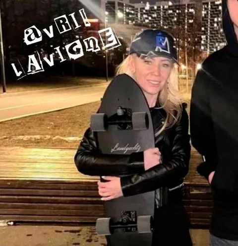 Avril Lavigne Holding a Skateboard