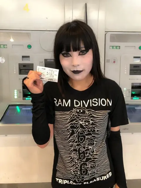 Goth Girl Holding a Ticket