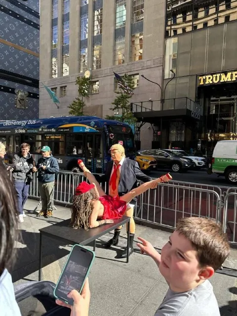 Trump Watches a Street Performance