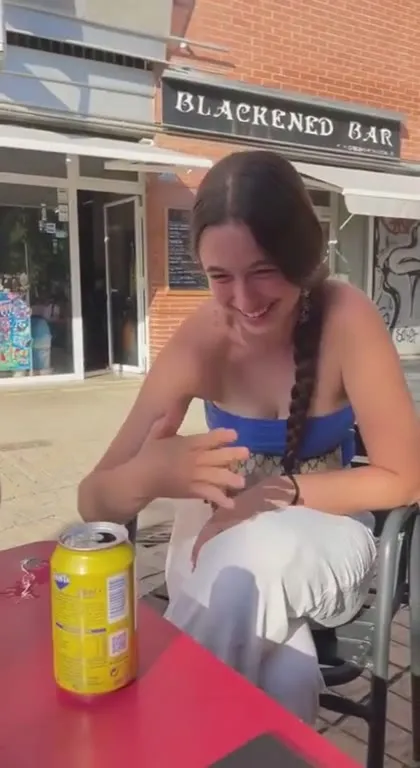 Laughing Woman Drinks from a Can