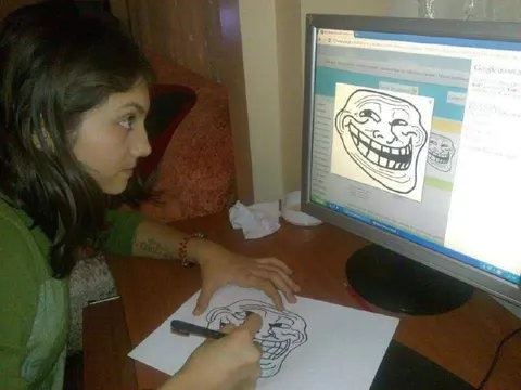 Девушка рисует троллфейс