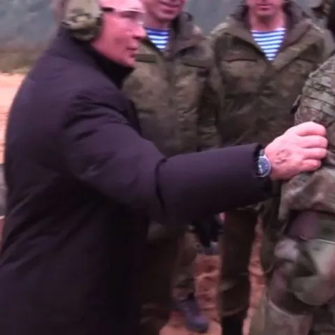 Мужчина трогает солдата за руку