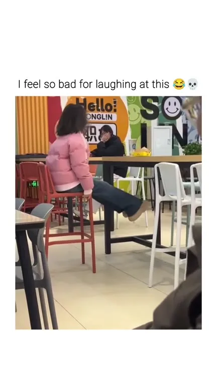 Woman Struggles With a Bar Chair