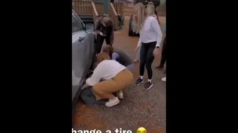 Women Trying to Change a Tire