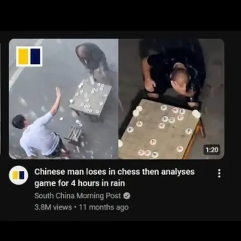 Chinese Man Analyzes Chess in Rain