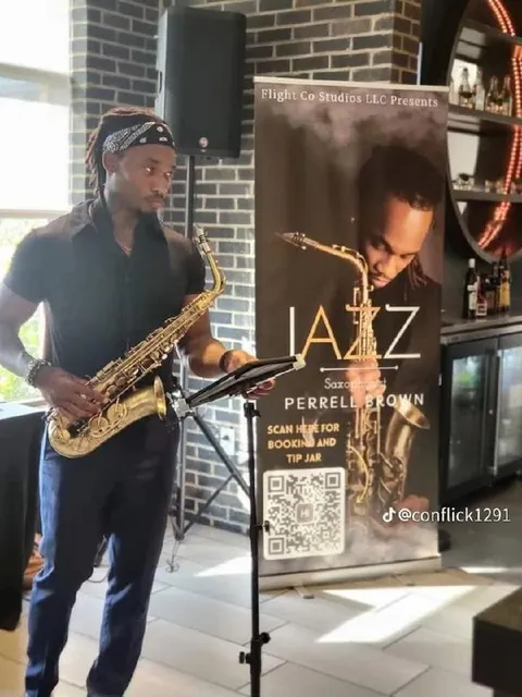 Saxophonist Performing Beside His Poster