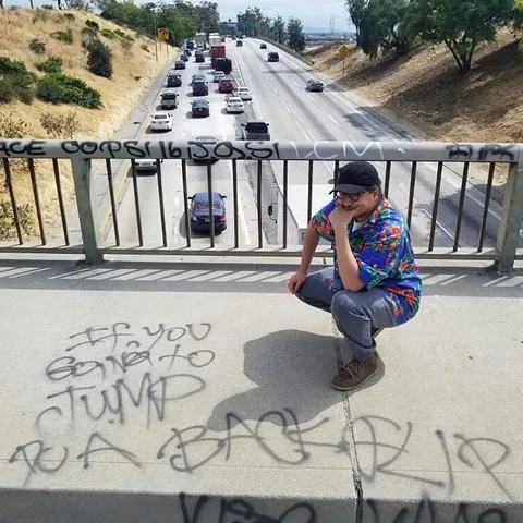 Man Contemplating Graffiti