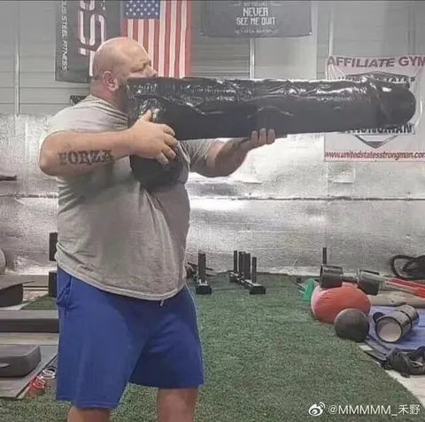 Man Lifts Giant Black Log