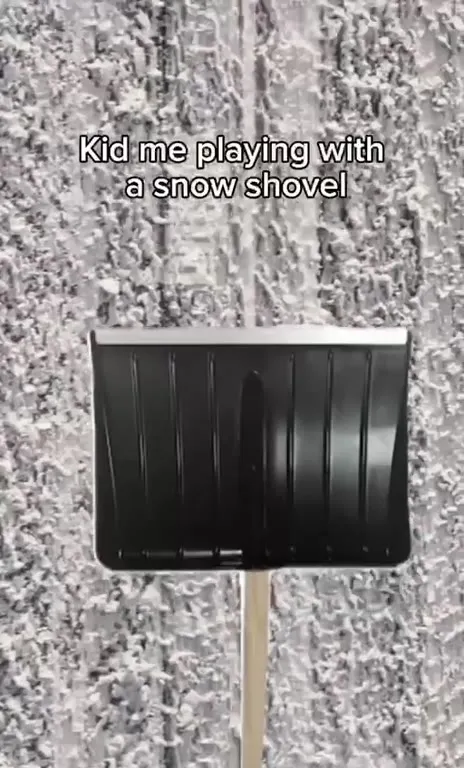 Kid Playing With a Snow Shovel