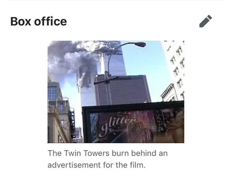 Twin Towers Burn Behind Glitter Ad