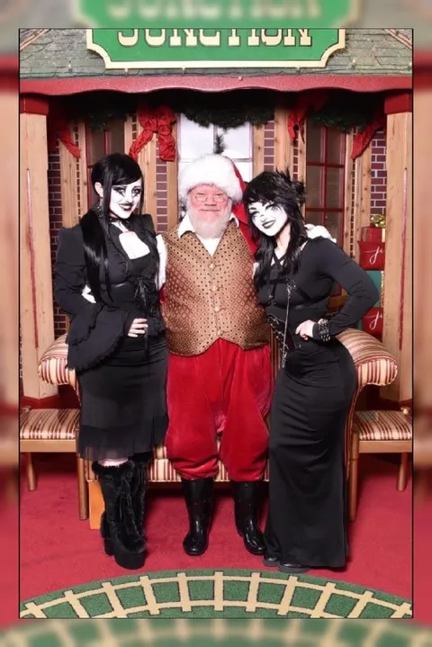 Santa Poses With Goth Women