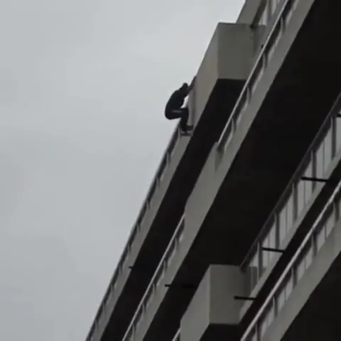 Man Climbs Down the Hotel