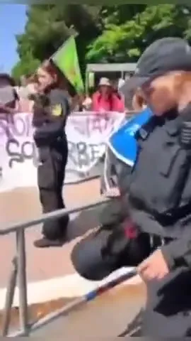 Police Officer Climbs the Barrier