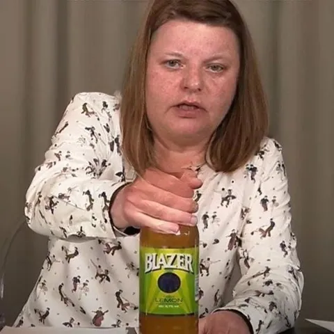 Woman Opening a Blazer Bottle