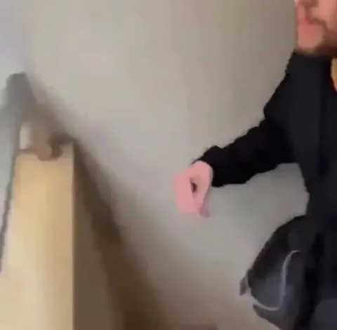 Balcony Hand Reaches for Nothing