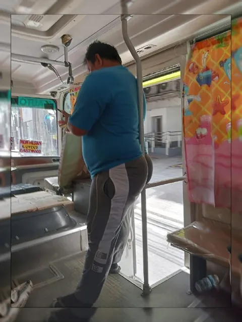 Man Standing on the Bus