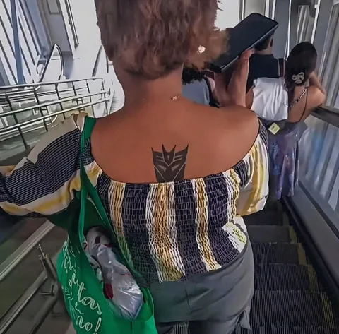 Decepticon Tattoo on the Escalator