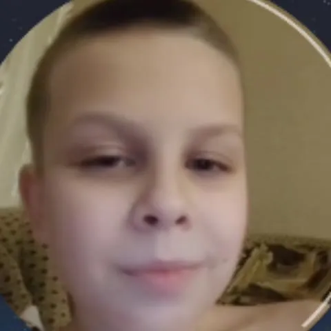 Мальчик хитро подмигивает
