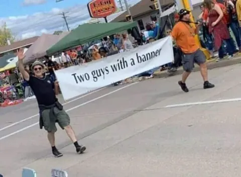 Two Guys With a Banner