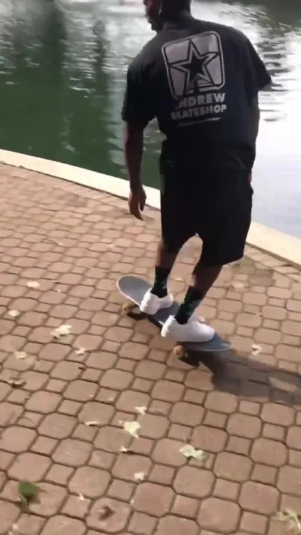 Two Skateboarders Fall Into Pond