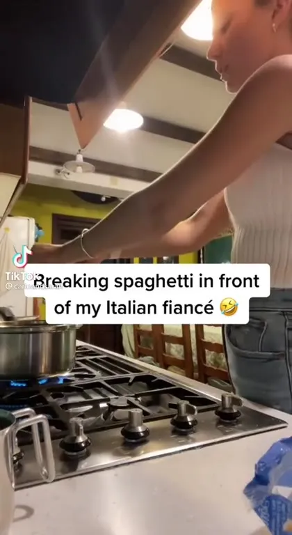 Cutting Spaghetti in Front of an Italian