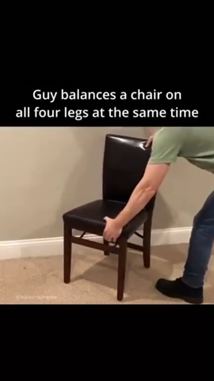 Guy Balances a Chair on Four Legs