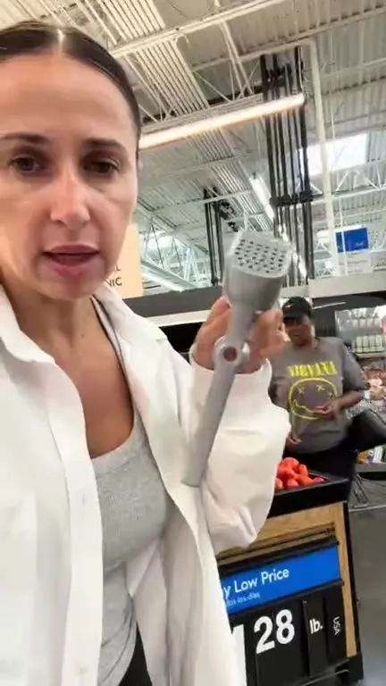 Woman Inspects Strange Kitchen Tool