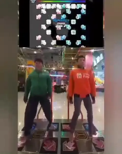 Two Men Playing Dance Dance Revolution