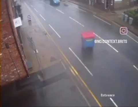 Bin Escapes Into Traffic