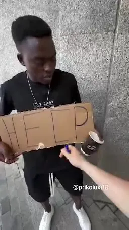 Man Holds a HELP Sign