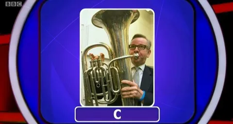 Man Playing Enormous Brass Instrument