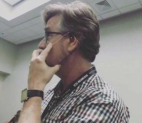 Man Adjusting His Glasses