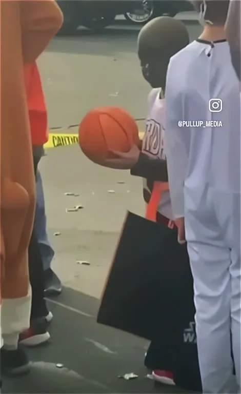 Child Holding a Basketball