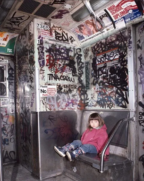 Girl Sitting in Graffiti-Covered Subway