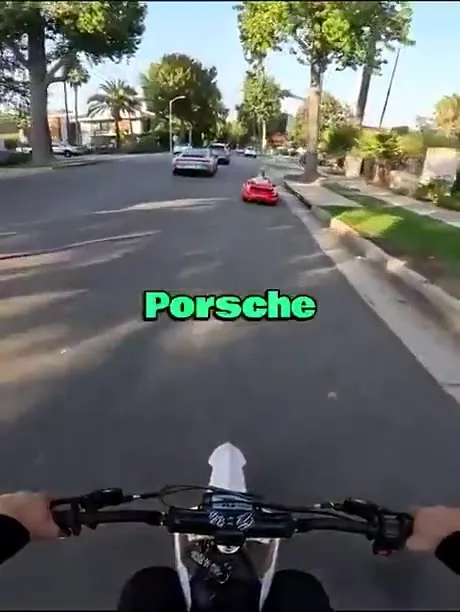 Dirt Bike Chases Tiny Porsche
