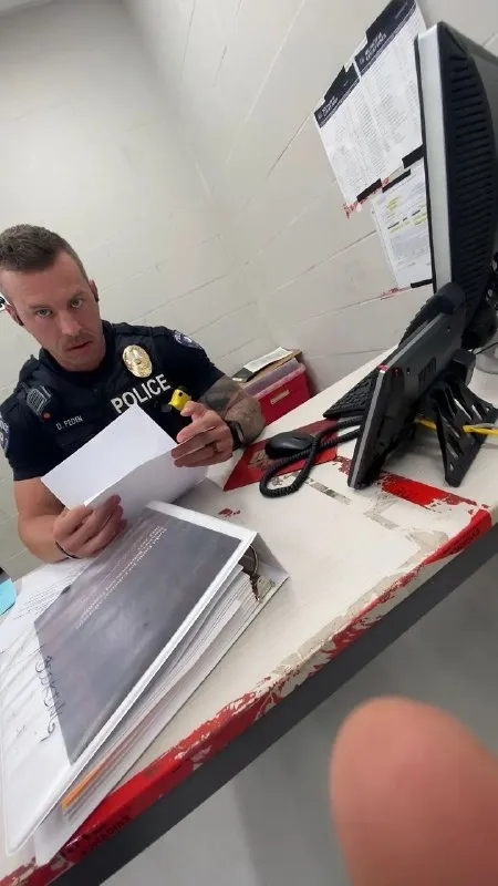 Police Officer Reading Papers