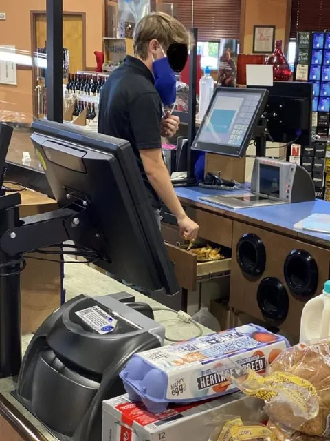Employee Reaches Into the Fryer