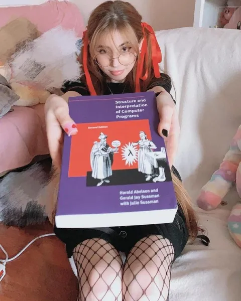 Girl Holding Computer Programming Book