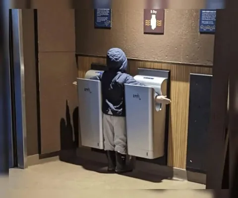 Child Between Hand Dryers