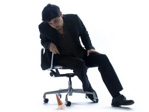 Man Sitting on a Tiny Chair