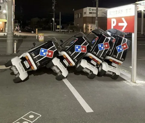 Domino's Scooters Leaning Together