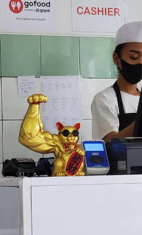 Muscular Lucky Cat at the Cashier
