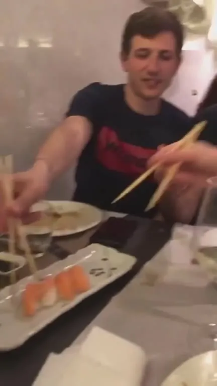 Man Eating Sushi with Chopsticks