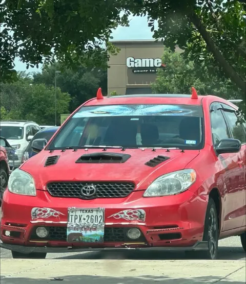 Red Toyota with Devil Horns